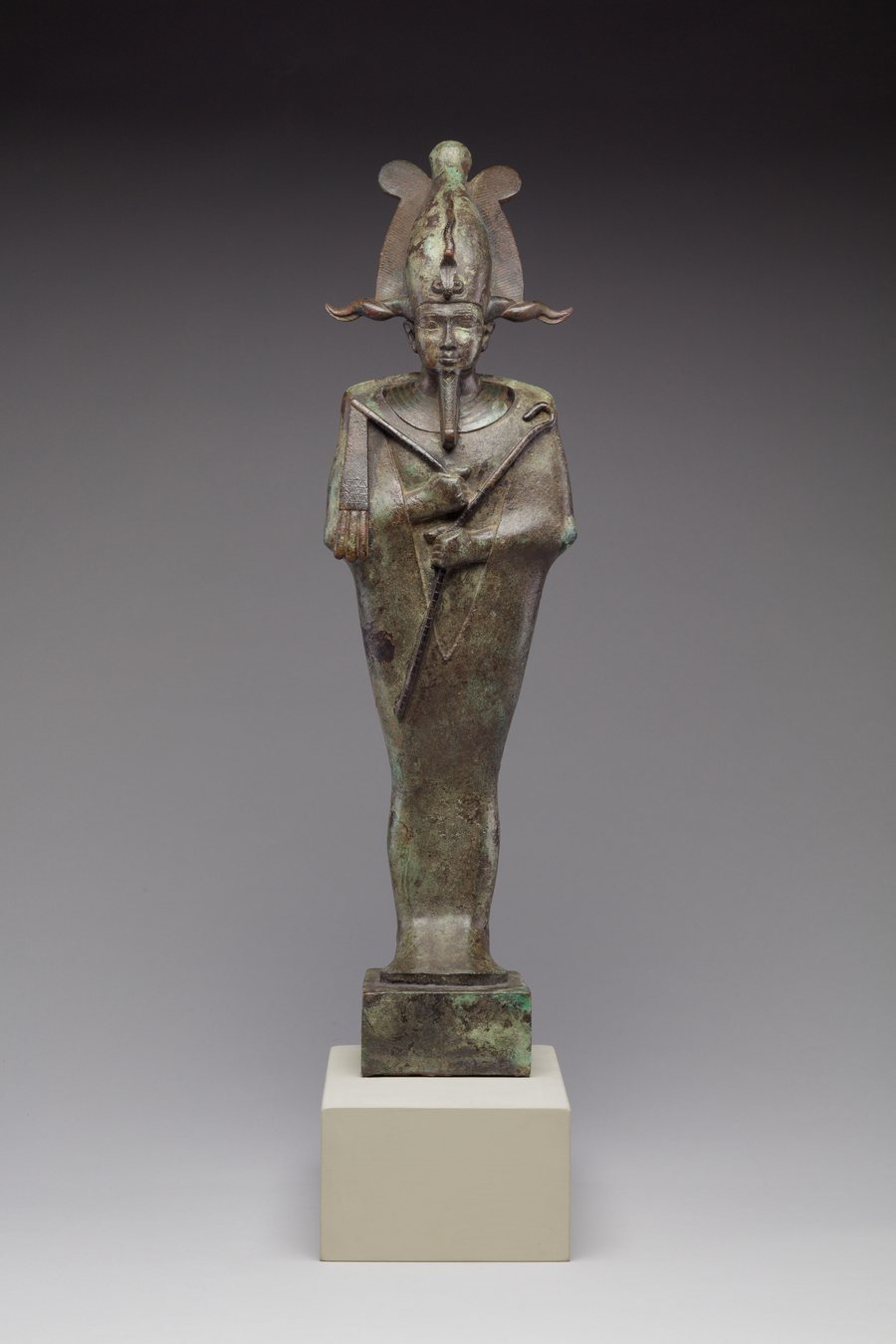 Bronze statuette of Osiris wrapped as a mummy, holding crook and flail, wearing the atef crown